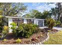 Charming home with lush landscaping and a well-maintained front garden at 603 Frances St, Nokomis, FL 34275