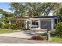 Charming home with lush landscaping and a well-maintained driveway at 603 Frances St, Nokomis, FL 34275