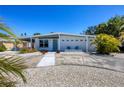 Inviting home with blue door, well-maintained lawn, xeriscaping, and comfortable outdoor seating at 6731 Northampton Pl, Bradenton, FL 34207