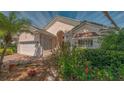 Charming home featuring a well-manicured lawn, lush landscaping, and beautiful curb appeal under a bright, sunny sky at 7133 Victoria Cir, University Park, FL 34201