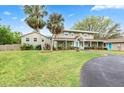 Charming two-story home with a well-maintained lawn, driveway, and vibrant landscaping at 730 Rellim Ln, Sarasota, FL 34232