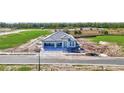 An aerial view shows a single-story home under construction with a three-car garage in a new community at 7561 Nighthawk Dr, Sarasota, FL 34241