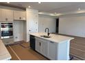 Well-lit kitchen boasting a spacious island with a sink and modern fixtures and stainless steel appliances at 7561 Nighthawk Dr, Sarasota, FL 34241