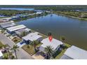 Waterfront home featuring mature palms and carport in a tranquil coastal setting near a scenic lake at 772 Imperial Dr, North Port, FL 34287