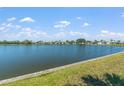 Scenic view of a tranquil lake surrounded by lush greenery and picturesque waterfront homes at 772 Imperial Dr, North Port, FL 34287