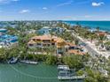 Aerial view of the waterfront home with dock under construction with coastal views and in a desirable community at 821 S Bay Blvd, Anna Maria, FL 34216