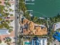 Aerial view of the new construction home with dock under construction and surrounded by trees and waterfront views at 821 S Bay Blvd, Anna Maria, FL 34216