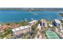 Beautiful aerial view of waterfront condos, tennis courts, and boat docks at 8625 Midnight Pass Rd # 305B, Sarasota, FL 34242