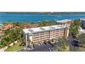 Attractive condo building with balconies, landscaping, and ample parking at 8625 Midnight Pass Rd # 305B, Sarasota, FL 34242