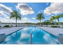 Resort-style community pool with lounge chairs and tropical landscaping at 10520 Boardwalk Loop # 503, Bradenton, FL 34202