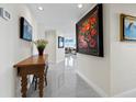 Elegant hallway featuring modern decor, artwork, and a glimpse into the bright living spaces at 1211 Gulf Of Mexico Dr # 601, Longboat Key, FL 34228