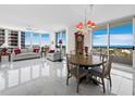 Bright living area with panoramic windows, modern furniture, and ocean views at 1211 Gulf Of Mexico Dr # 601, Longboat Key, FL 34228