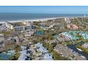 An aerial view of the community shows the beach, the intercoastal, tennis courts, and pristine landscaping at 1239 Siesta Bayside Dr # 1239C, Sarasota, FL 34242