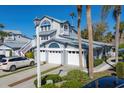 Inviting coastal-style home with multi car garage, white trim, meticulously landscaped grounds, and a paved driveway at 1239 Siesta Bayside Dr # 1239C, Sarasota, FL 34242