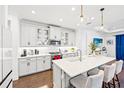 Bright kitchen with white cabinets, quartz countertops, pendant lighting, and stainless steel appliances at 12959 Seasong Ter, Bradenton, FL 34211