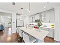 Modern kitchen with white cabinetry, stainless steel appliances, and a large island with seating at 12959 Seasong Ter, Bradenton, FL 34211