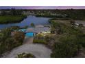 Waterfront home features a private dock, tiki hut, pool and lovely landscaping at 1410 San Jose Dr, Englewood, FL 34223