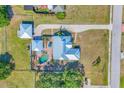 An aerial view of property with pool, patio, detached garage and large lawn at 1489 17Th W St, Palmetto, FL 34221