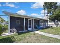View of a screened-in back porch and grassy yard at 14914 Old Dixie Hwy, Hudson, FL 34667