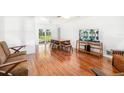 Spacious living room featuring laminate floors and sliding glass doors to backyard area with pool at 1525 Fleetwood Dr, Sarasota, FL 34232