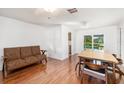 Cozy living room with laminate flooring and sliding glass doors leading to the pool area at 1525 Fleetwood Dr, Sarasota, FL 34232