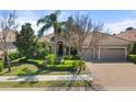 Charming single-story home with well-manicured landscaping and a three-car garage, perfect for curb appeal at 15508 Leven Links Pl, Lakewood Ranch, FL 34202