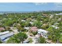 Stunning aerial view of a vibrant neighborhood with beautiful homes surrounded by mature trees and blue skies at 1879 Hibiscus St, Sarasota, FL 34239
