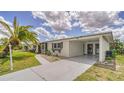 Single-story home with an attached carport and well-manicured landscaping at 22201 Olean Blvd, Port Charlotte, FL 33952