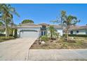 Charming single-story home with a well-manicured lawn and beautiful landscaping at 2311 Falcon Trace Ln, Nokomis, FL 34275
