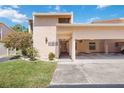Charming condo exterior featuring stucco siding, covered parking, and well-maintained landscaping at 2347 Beneva Ter # 2251, Sarasota, FL 34232
