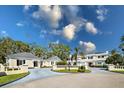 Elegant estate boasts manicured grounds, circular driveway, and classic architectural details at 236 Saint James Park, Osprey, FL 34229