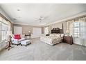 Spacious main bedroom with a four-poster bed, sitting area, and large windows with natural light at 236 Saint James Park, Osprey, FL 34229