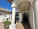 Covered entryway with decorative light fixture and tile, leading to a black front door at 316 Orlando Blvd, Port Charlotte, FL 33954