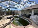 Screened-in pool area with a spa, with a view of backyard at 316 Orlando Blvd, Port Charlotte, FL 33954