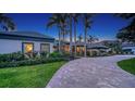 Beautiful home exterior with a winding paver driveway lined with manicured landscaping at 316 W Royal Flamingo Dr, Sarasota, FL 34236