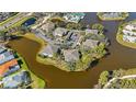 Aerial view of homes in a waterfront community with mature trees and lush landscaping at 321 108Th W St # 120, Bradenton, FL 34209