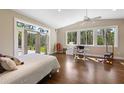 Bright bedroom featuring hardwood floors, a ceiling fan, and access to the outdoors at 325 12Th W Ave, Palmetto, FL 34221