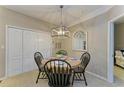 Cozy dining area featuring a round table and modern light fixture at 4110 Central Sarasota Pkwy # 123, Sarasota, FL 34238