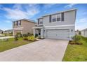Two-story home with a concrete driveway, attached two-car garage, and neutral exterior paint at 4231 Autumn Fog Ct, Palmetto, FL 34221