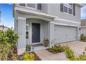 Inviting entryway with gray paint, a 'no soliciting' sign, and colorful landscaping at 4231 Autumn Fog Ct, Palmetto, FL 34221