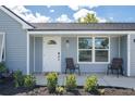 Inviting front porch with seating and fresh landscaping, enhancing the curb appeal of this home at 4493 Mckibben Dr, North Port, FL 34287