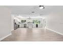 Spacious open floor plan with sleek tile flooring, connecting the living area and a stylish kitchen with stainless appliances at 4493 Mckibben Dr, North Port, FL 34287
