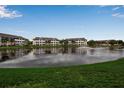 Condominium buildings alongside a peaceful pond with fountain and green lawn at 4802 51St W St # 1714, Bradenton, FL 34210