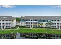 Lakeside condominium building with screened patios and well-manicured lawn at 4802 51St W St # 1714, Bradenton, FL 34210