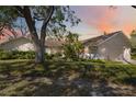 Beautiful single-story home with a well-manicured lawn and mature trees, showcasing a peaceful suburban setting at 4965 Marsh Field Rd, Sarasota, FL 34235