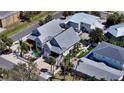 Beautiful coastal home with a pool, fenced yard, outdoor lounging area, and lush tropical landscaping at 5007 2Nd Ave, Holmes Beach, FL 34217
