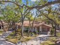 Charming home with a brown roof, carport and lush landscaping with mature trees in a quiet neighborhood at 5117 27Th W St # 5117, Bradenton, FL 34207