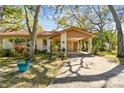 Charming home featuring a covered carport, mature trees, colorful landscaping and a well-manicured lawn at 5117 27Th W St # 5117, Bradenton, FL 34207