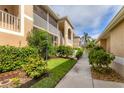 The exterior of the condo features a screened in porch and lush landscaping at 5240 Hyland Hills Ave # 1426, Sarasota, FL 34241