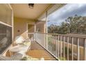 Relaxing screened-in porch with comfortable seating and a tranquil view at 5240 Hyland Hills Ave # 1426, Sarasota, FL 34241